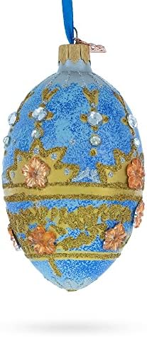 Flores douradas no enfeite de ovo de vidro azul manchado 4 polegadas